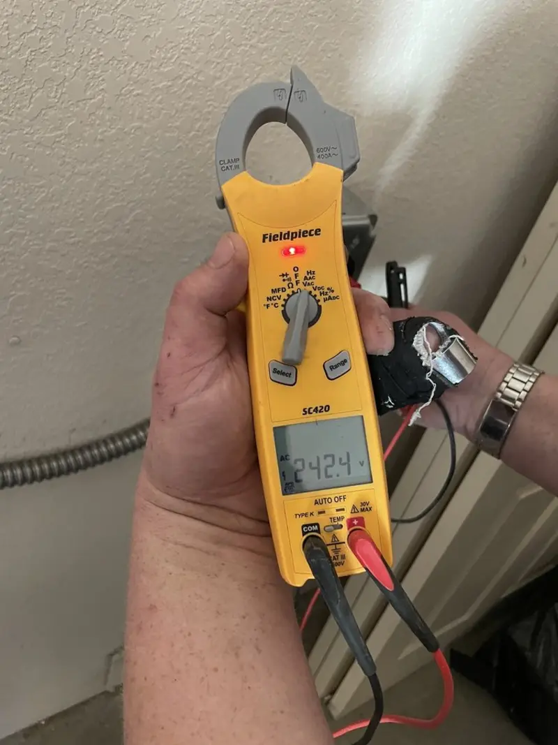 Voltage testing with clamp meter during Recessed Lighting Installation in Burlington